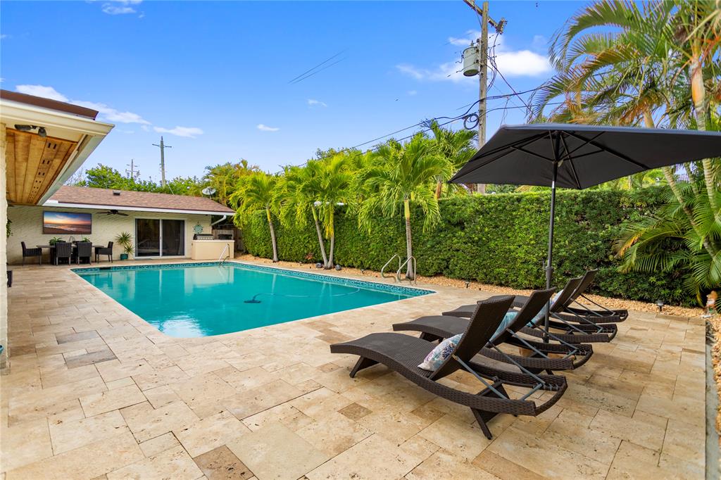 1650 Northeast 27th Avenue Pompano Beach, FL 33062 - Photo 65 of 90 a view of a patio with a table and chairs under an umbrella