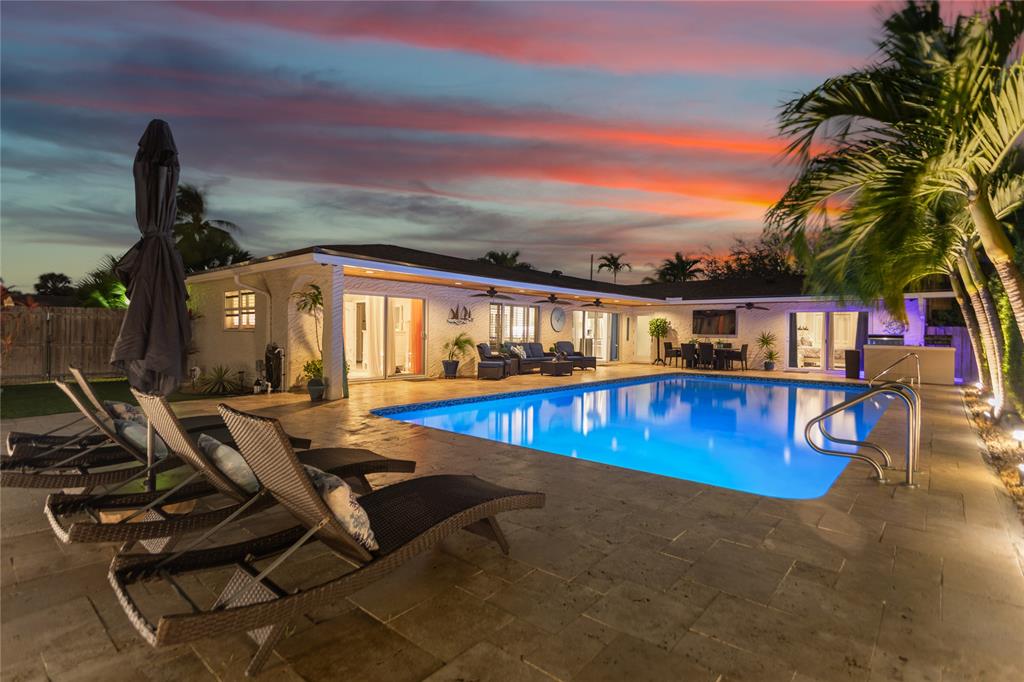 1650 Northeast 27th Avenue Pompano Beach, FL 33062 - Photo 69 of 90 a view of a swimming pool with chair and tables