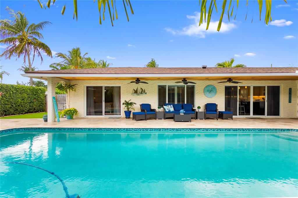 1650 Northeast 27th Avenue Pompano Beach, FL 33062 - Photo 75 of 90 a front view of a house with swimming pool having outdoor seating