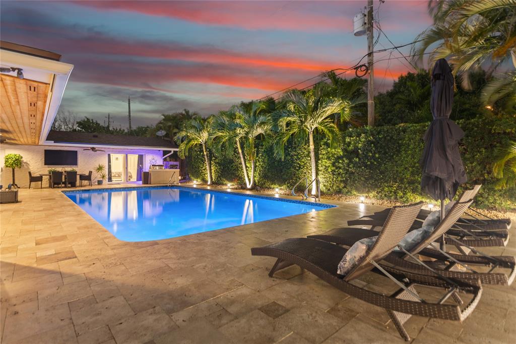 1650 Northeast 27th Avenue Pompano Beach, FL 33062 - Photo 78 of 90 a view of a swimming pool with a lounge chairs