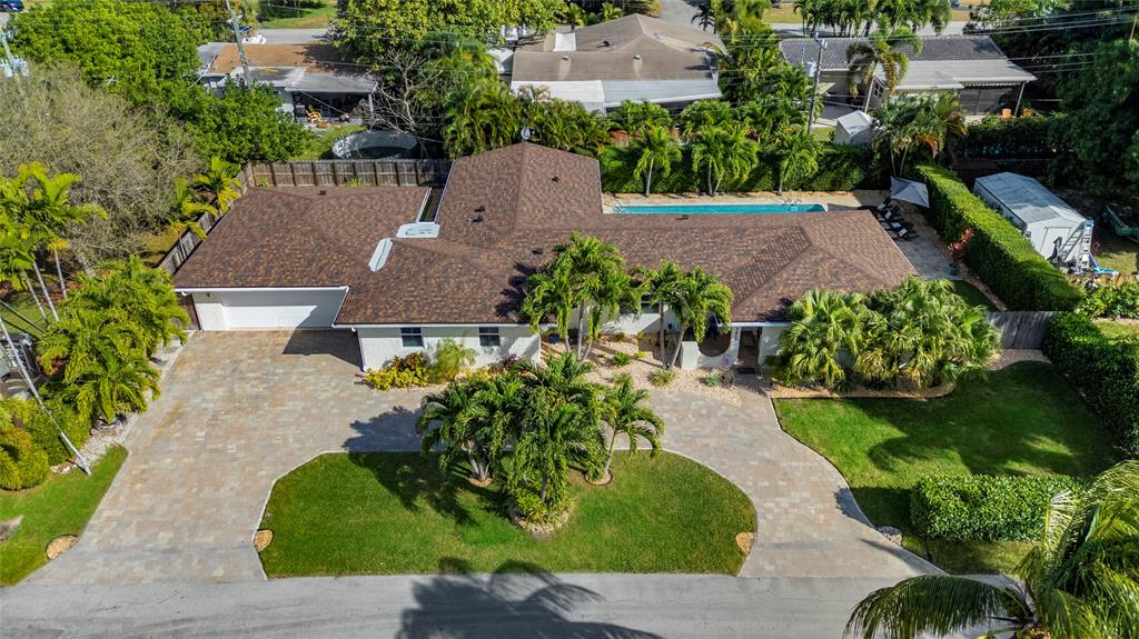 1650 Northeast 27th Avenue Pompano Beach, FL 33062 - Photo 8 of 90 an aerial view of a house with a yard and tennis court