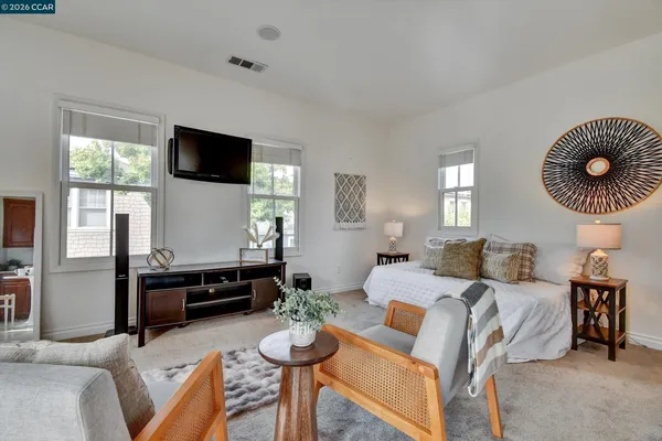 a bedroom with furniture and a flat screen tv