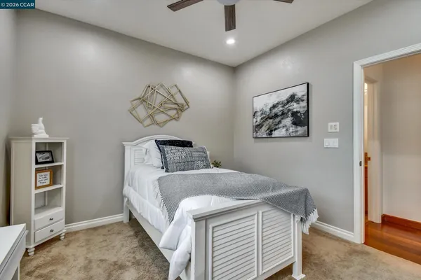 a bedroom with a bed and a painting on the wall