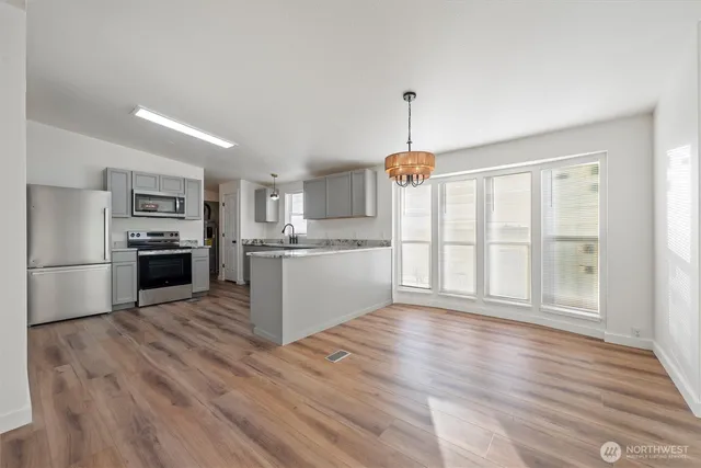 a kitchen with stainless steel appliances a refrigerator sink and cabinets