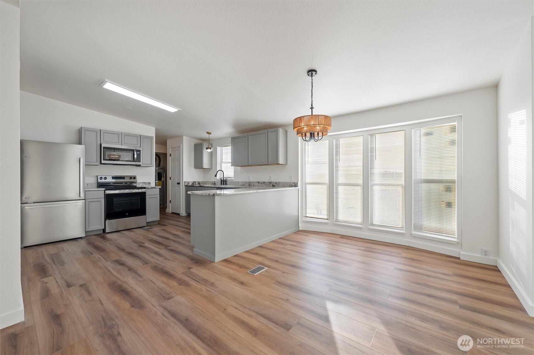 2326 Stoneridge Road Northeast Moses Lake, WA 98837 - Photo 15 of 37 a kitchen with stainless steel appliances a refrigerator sink and cabinets