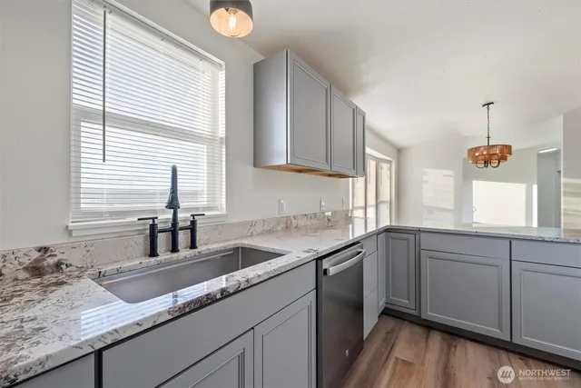 a kitchen with granite countertop a sink and a window