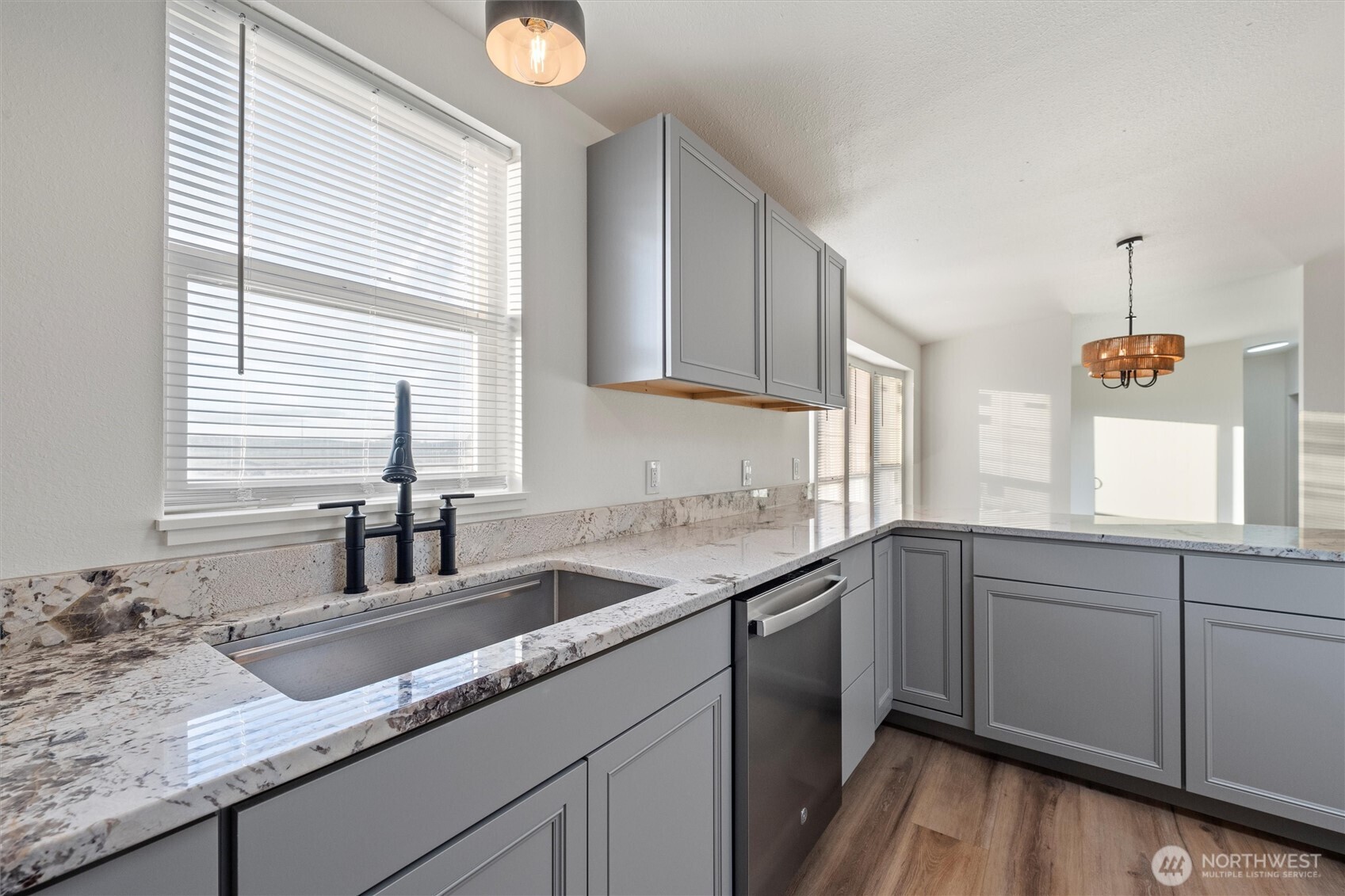 2326 Stoneridge Road Northeast Moses Lake, WA 98837 - Photo 17 of 37 a kitchen with granite countertop a sink and a window