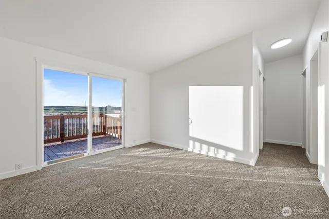 an empty room with furniture and a window