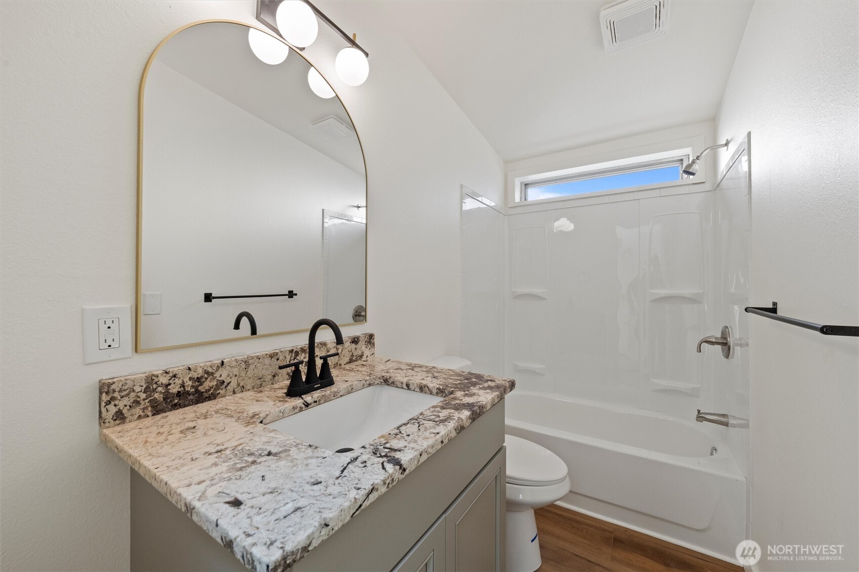 2326 Stoneridge Road Northeast Moses Lake, WA 98837 - Photo 21 of 37 a bathroom with a granite countertop sink a toilet a mirror and shower