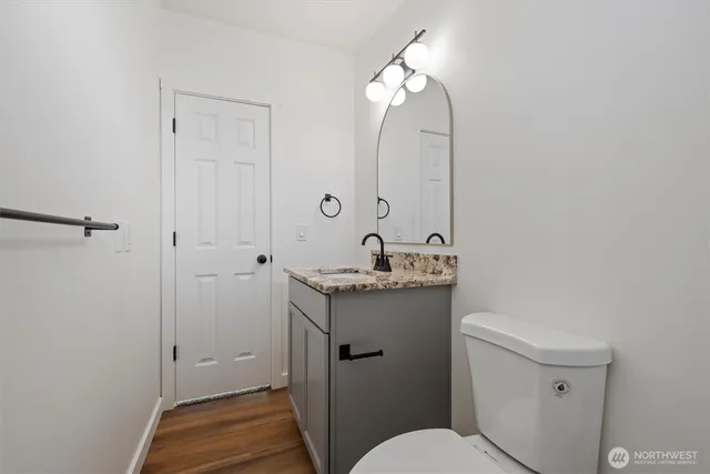 a bathroom with a granite countertop sink toilet and shower