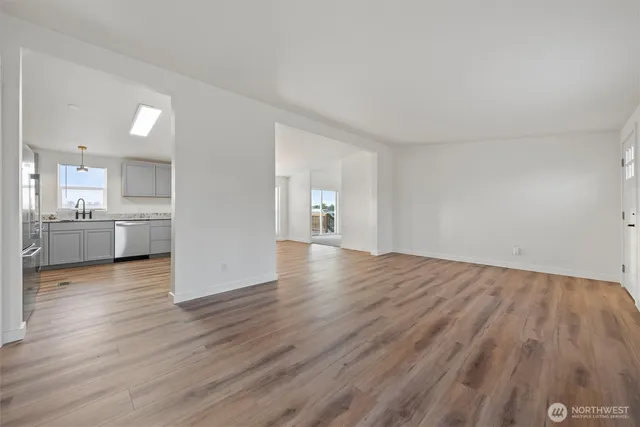 a view of a kitchen with wooden floor and a sink