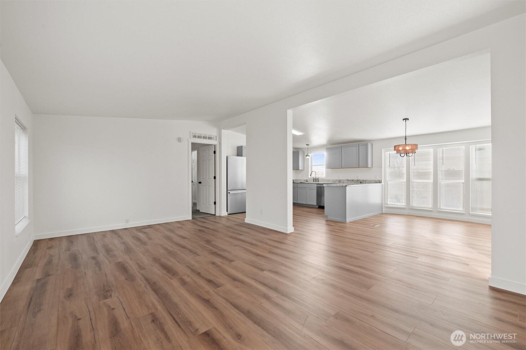 2326 Stoneridge Road Northeast Moses Lake, WA 98837 - Photo 9 of 37 a view of empty room with wooden floor and windows