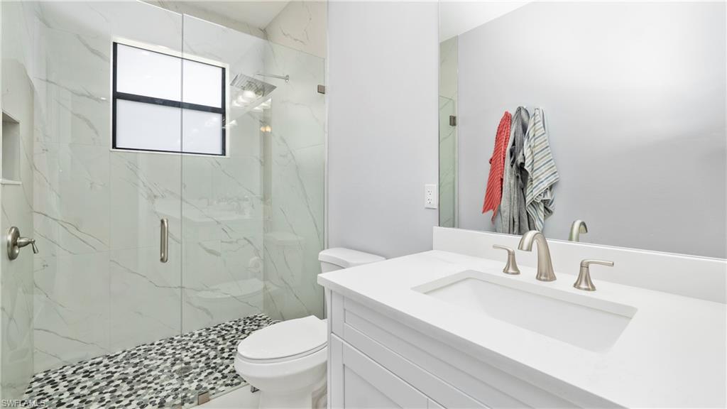 4571 22nd Street Northeast Naples, FL 34120 - Photo 28 of 47 Full bathroom with vanity and a marble finish shower