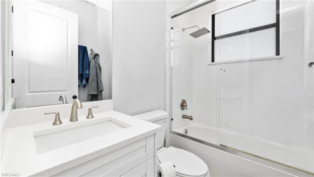 4571 22nd Street Northeast Naples, FL 34120 - Photo 29 of 47 Full bath with vanity and combined bath / shower with glass door