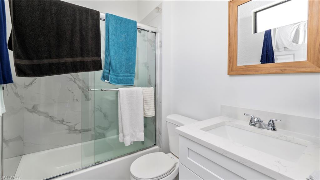 4571 22nd Street Northeast Naples, FL 34120 - Photo 30 of 47 Full bathroom with vanity and shower / bath combination with glass door