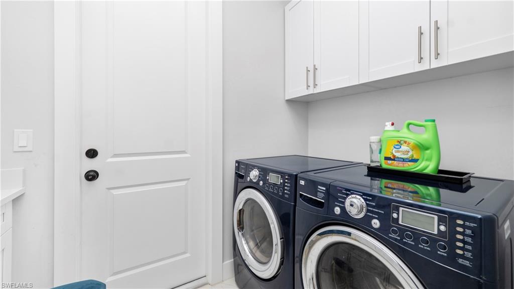 4571 22nd Street Northeast Naples, FL 34120 - Photo 31 of 47 Laundry room with washing machine and clothes dryer and cabinet space