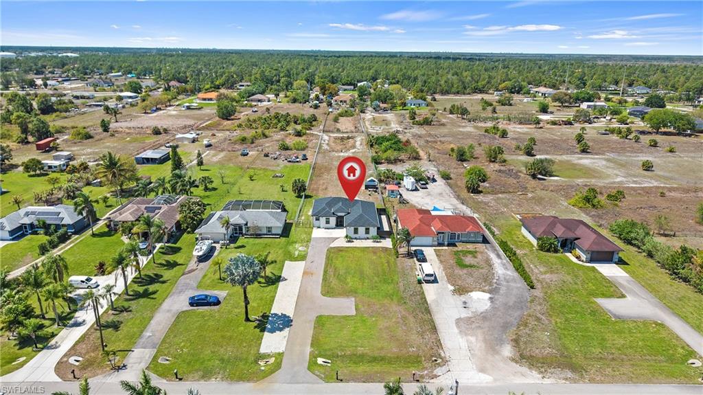 4571 22nd Street Northeast Naples, FL 34120 - Photo 45 of 47 Aerial perspective of suburban area with a forest