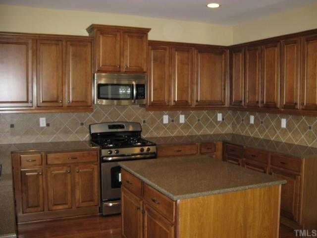 2101 Lower Lake Road Wake Forest, NC 27587 - Photo 3 of 12 Beautiful kitchen with Zodiac quartz counters, tile backsplash, stainless appliances, and more! Kitchen