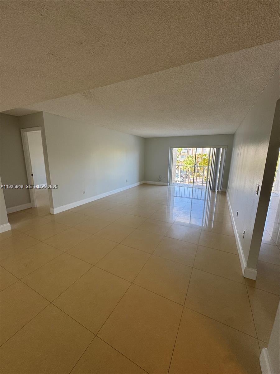 7745 Southwest 86th Street, Unit D315 Miami, FL 33143 - Photo 4 of 7 a view of an empty room and a window