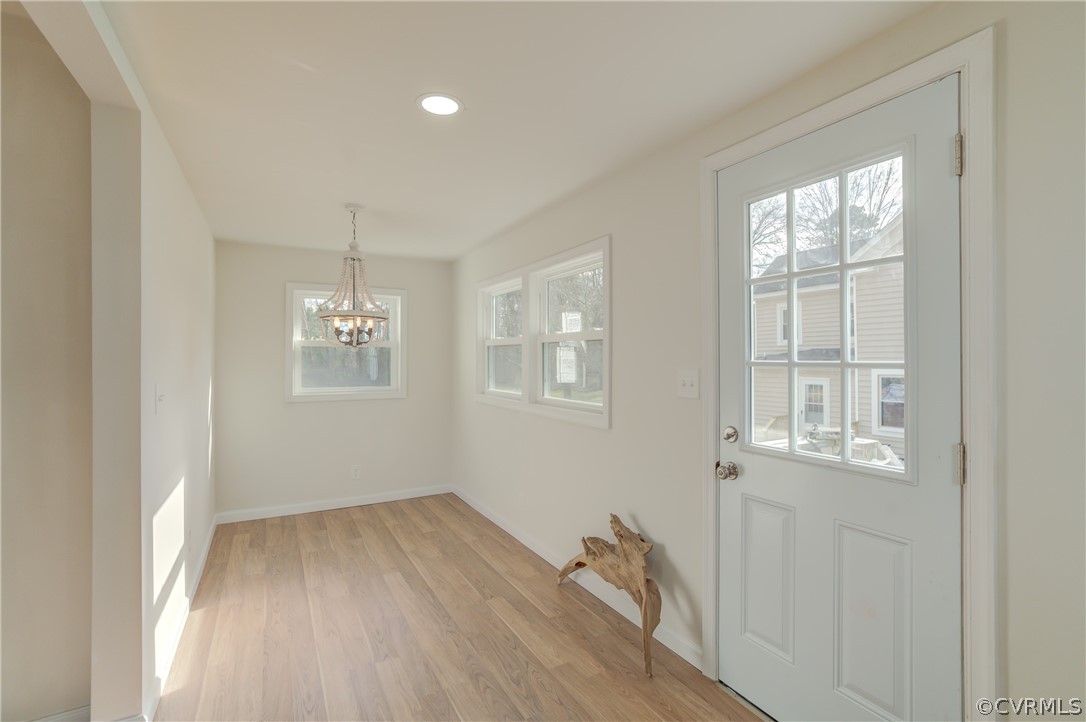 4462 Windmill Point Road White Stone, VA 22578 - Photo 11 of 48 wooden floor in an empty room with a window
