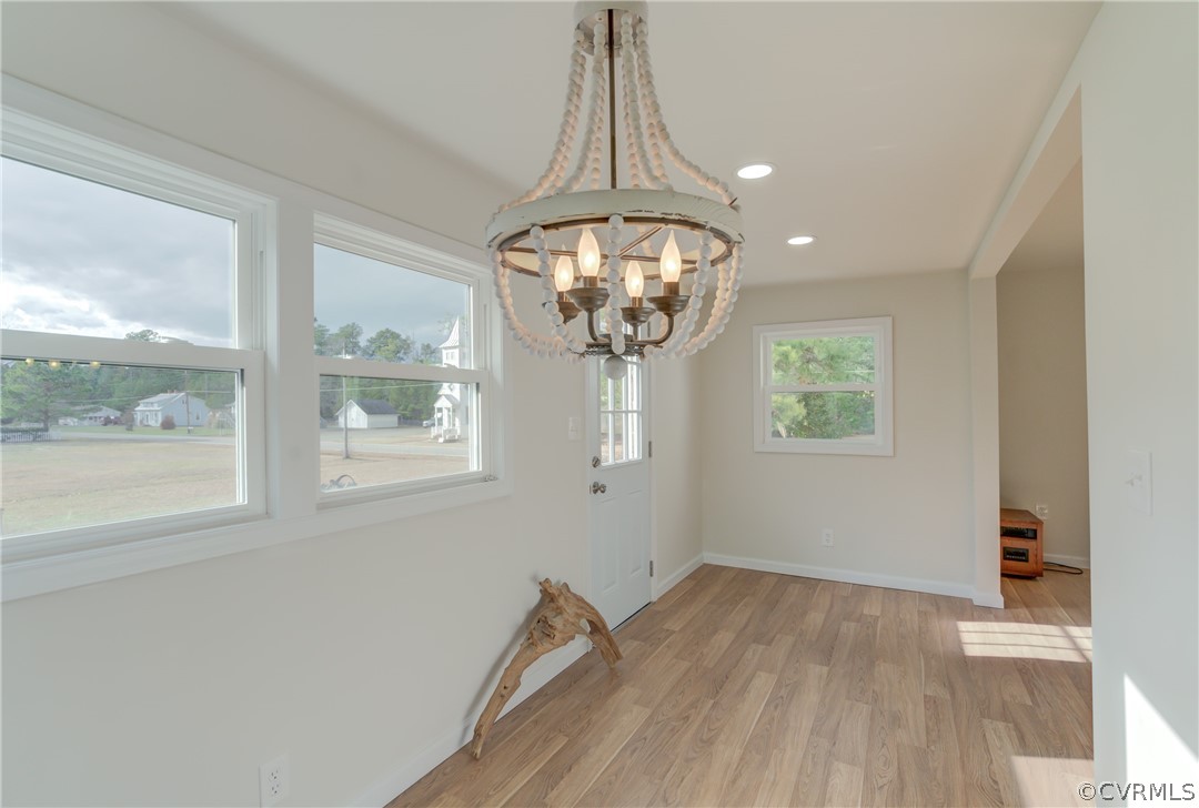4462 Windmill Point Road White Stone, VA 22578 - Photo 12 of 48 a view of empty room with wooden floor and windows