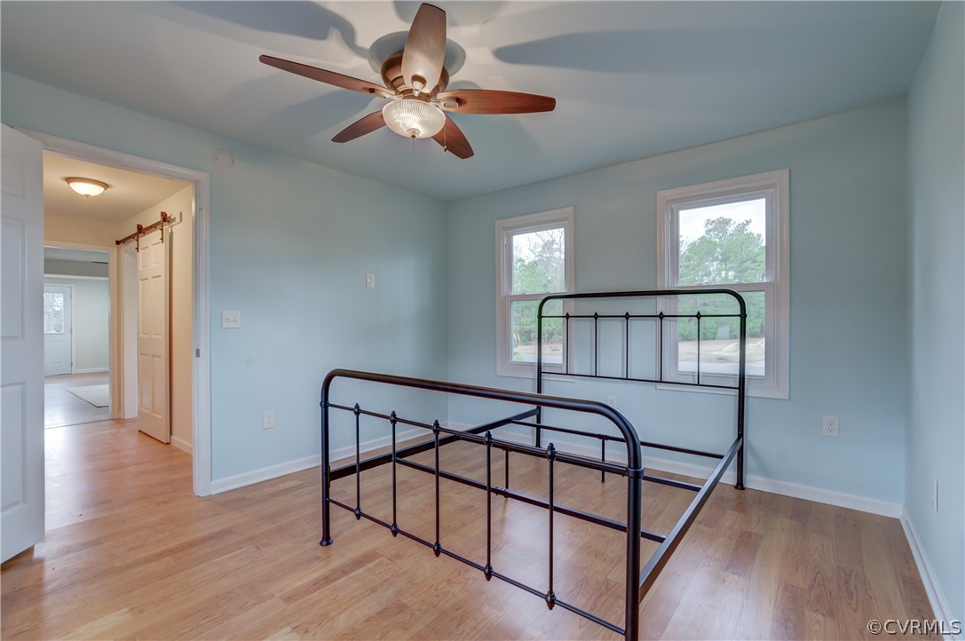4462 Windmill Point Road White Stone, VA 22578 - Photo 19 of 48 a view of a hallway with wooden floor and staircase