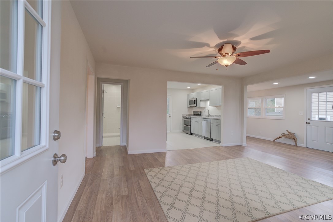 4462 Windmill Point Road White Stone, VA 22578 - Photo 3 of 48 a view of a big room with wooden floor and a kitchen