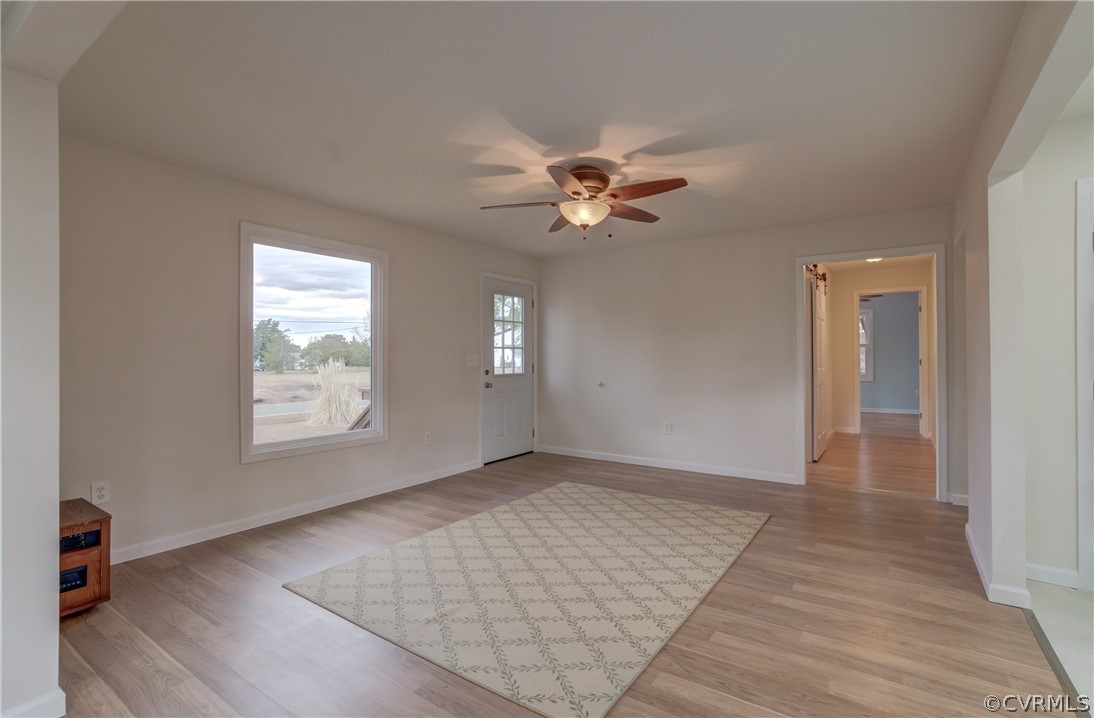 4462 Windmill Point Road White Stone, VA 22578 - Photo 4 of 48 an empty room with wooden floor and windows