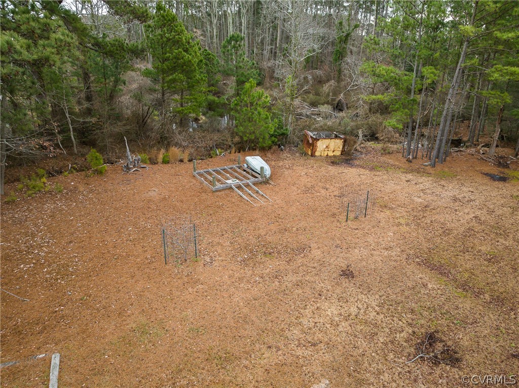 4462 Windmill Point Road White Stone, VA 22578 - Photo 48 of 48 a backyard of a house with large trees and covered with wooden fence