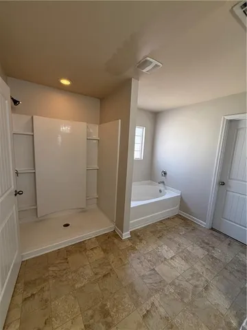 a bathroom with a shower and a tub