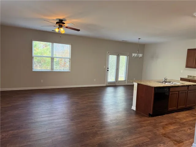a view of room with hardwood flooring and ceiling fan
