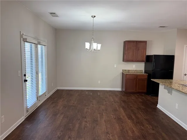a kitchen with kitchen island a counter top space a sink stainless steel appliances and cabinets