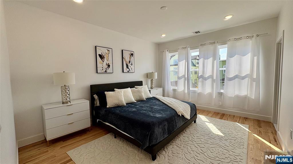 367 Devon Street, Unit 2 Kearny, NJ 07032 - Photo 15 of 30 a large bedroom with a bed and glass window
