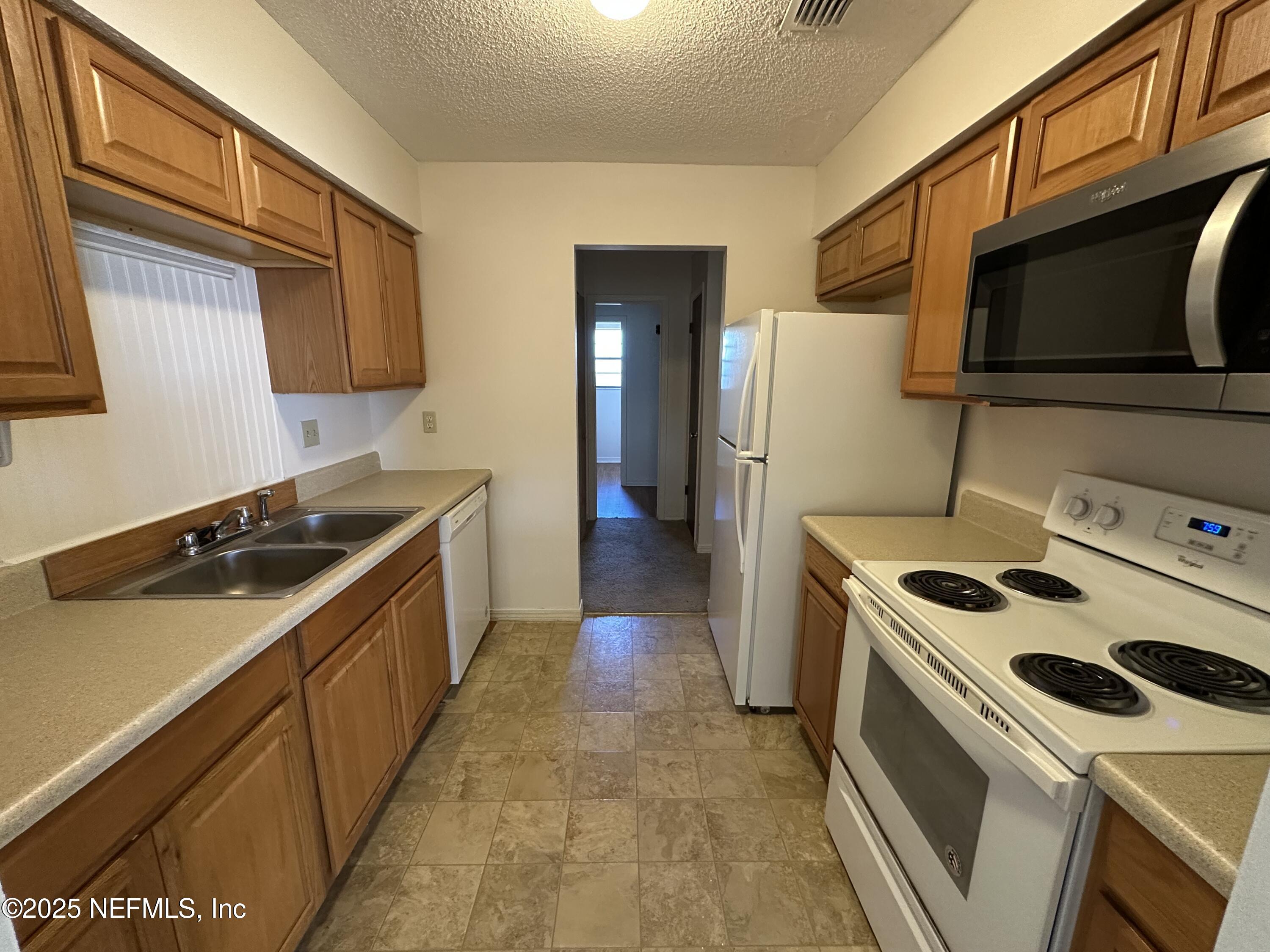 2934 Shelby Drive Orange Park, FL 32073 - Photo 3 of 6 a kitchen with a stove and a microwave