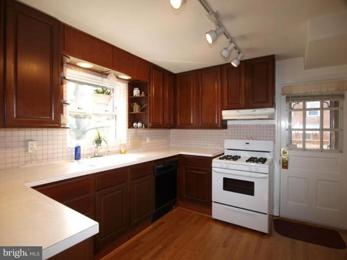 2600 Dawson Avenue Silver Spring, MD 20902 - Photo 16 of 24 a kitchen with a stove sink and cabinets