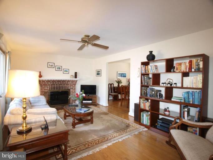 2600 Dawson Avenue Silver Spring, MD 20902 - Photo 3 of 24 a living room with furniture a fireplace and a book shelf