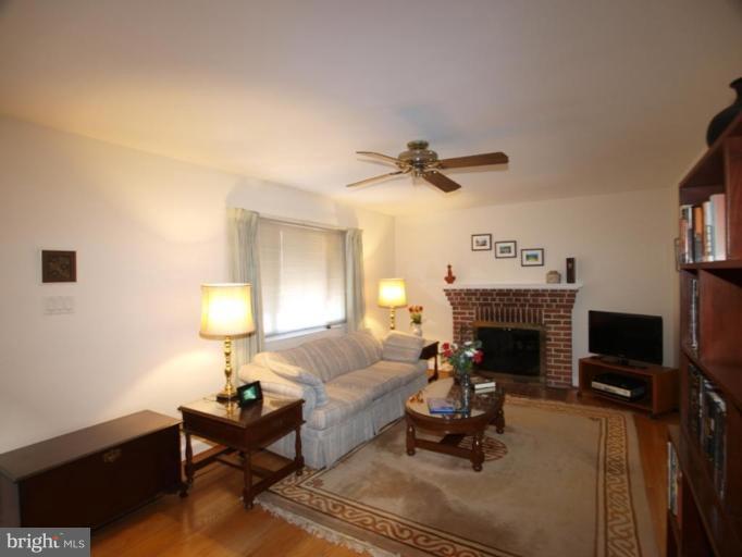 2600 Dawson Avenue Silver Spring, MD 20902 - Photo 4 of 24 a living room with furniture a fireplace and a flat screen tv
