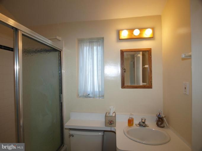 2600 Dawson Avenue Silver Spring, MD 20902 - Photo 10 of 24 a bathroom with a toilet sink and mirror