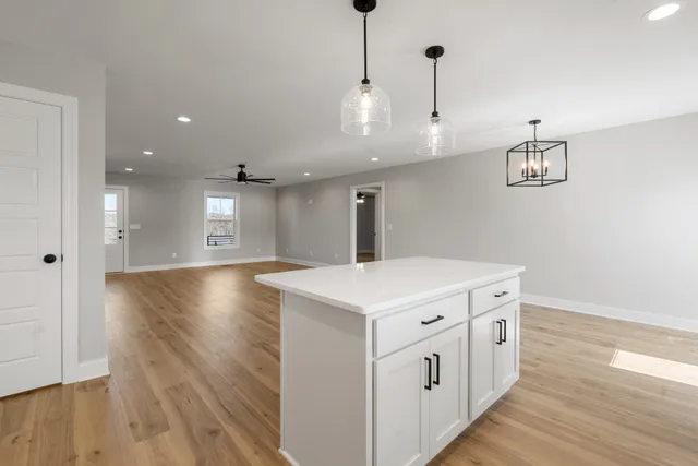 a kitchen with wooden floor and window