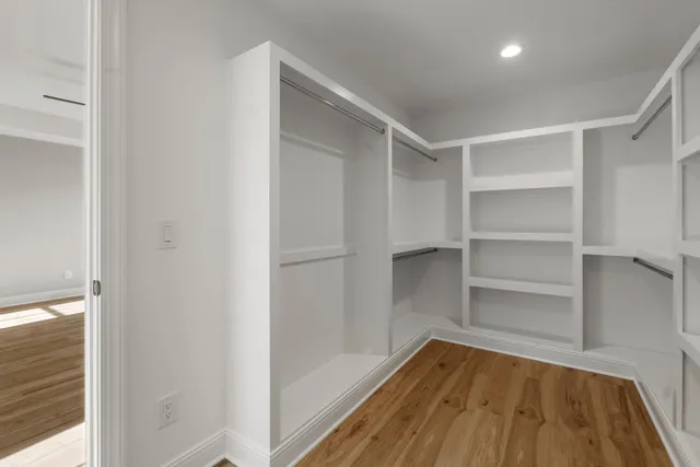 a view of a room with wooden floor