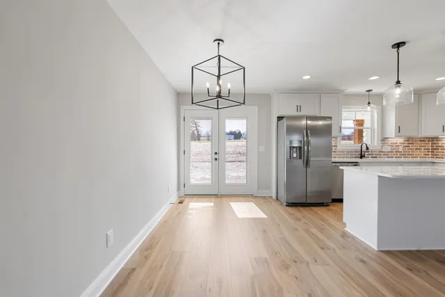 a kitchen with stainless steel appliances a refrigerator sink and cabinets