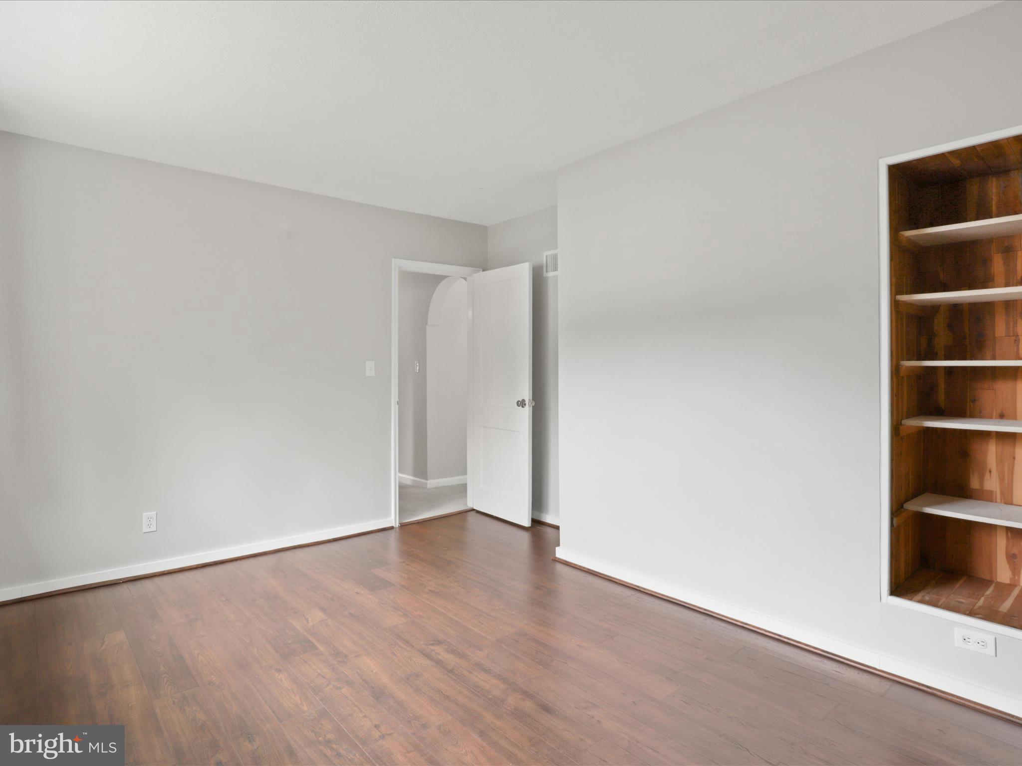 7533 Hollindale Court Alexandria, VA 22306 - Photo 23 of 78 Bedroom with LVP flooring and built in shelving
