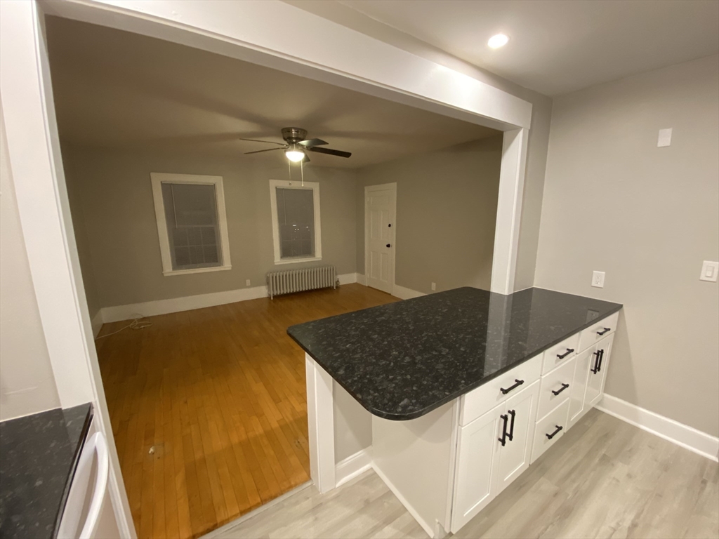 a kitchen with stainless steel appliances granite countertop a sink and a stove