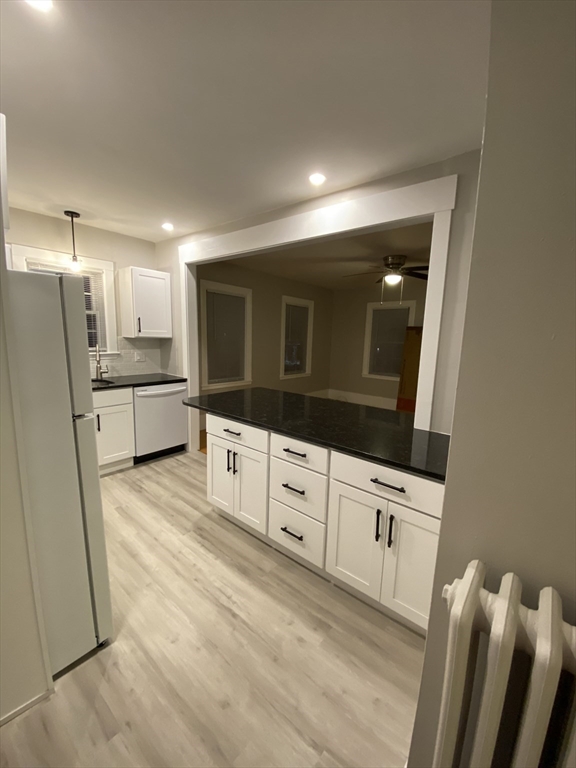 91 Main, Unit 2W Easton, MA 02356 - Photo 5 of 8 a view of a kitchen with wooden cabinet and a refrigerator