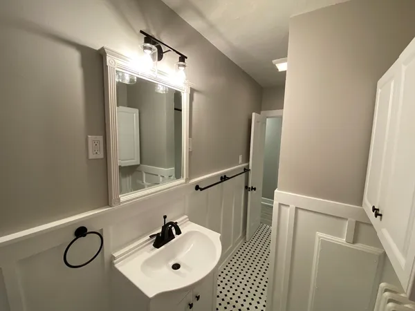 a bathroom with a sink and mirror