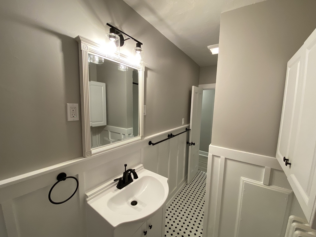 91 Main, Unit 2W Easton, MA 02356 - Photo 8 of 8 a bathroom with a sink and mirror