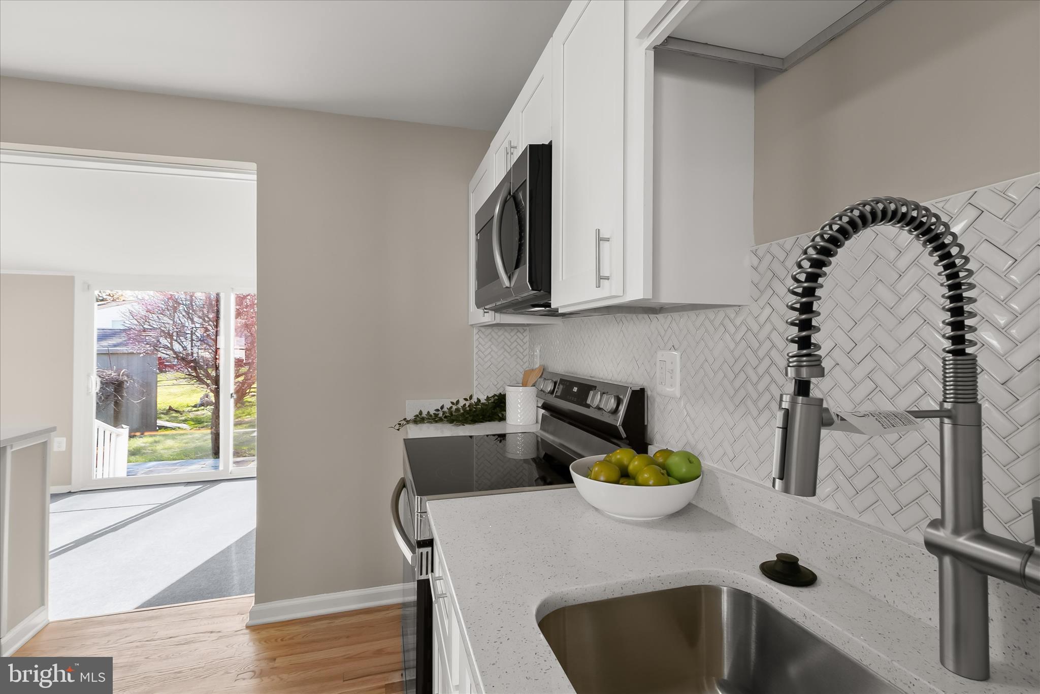 13218 Holdridge Road Silver Spring, MD 20906 - Photo 15 of 51 a kitchen with a table and a sink