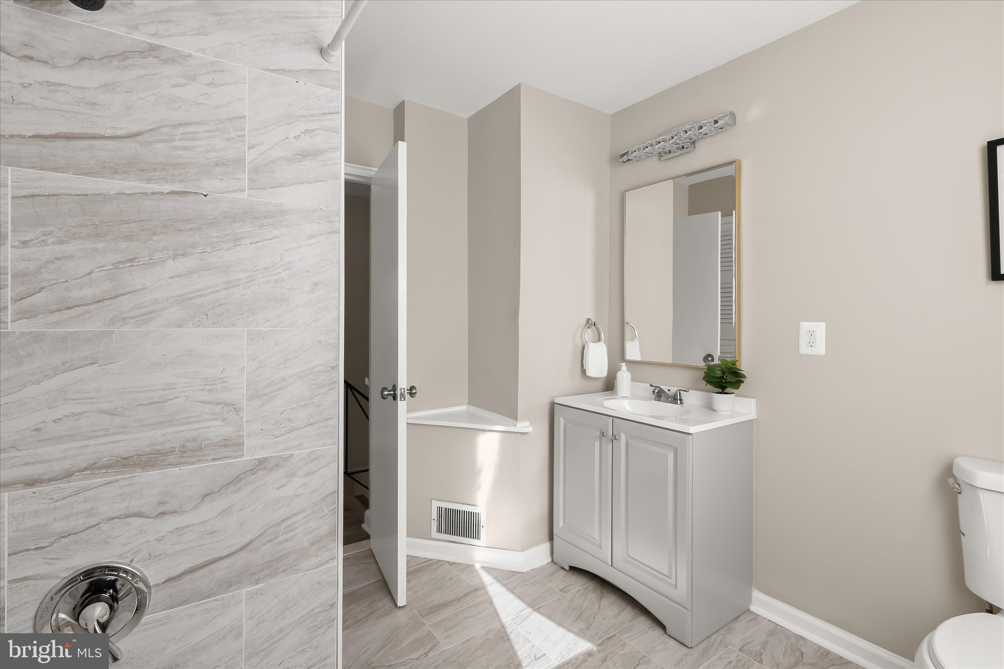 13218 Holdridge Road Silver Spring, MD 20906 - Photo 25 of 51 a bathroom with a sink and a mirror