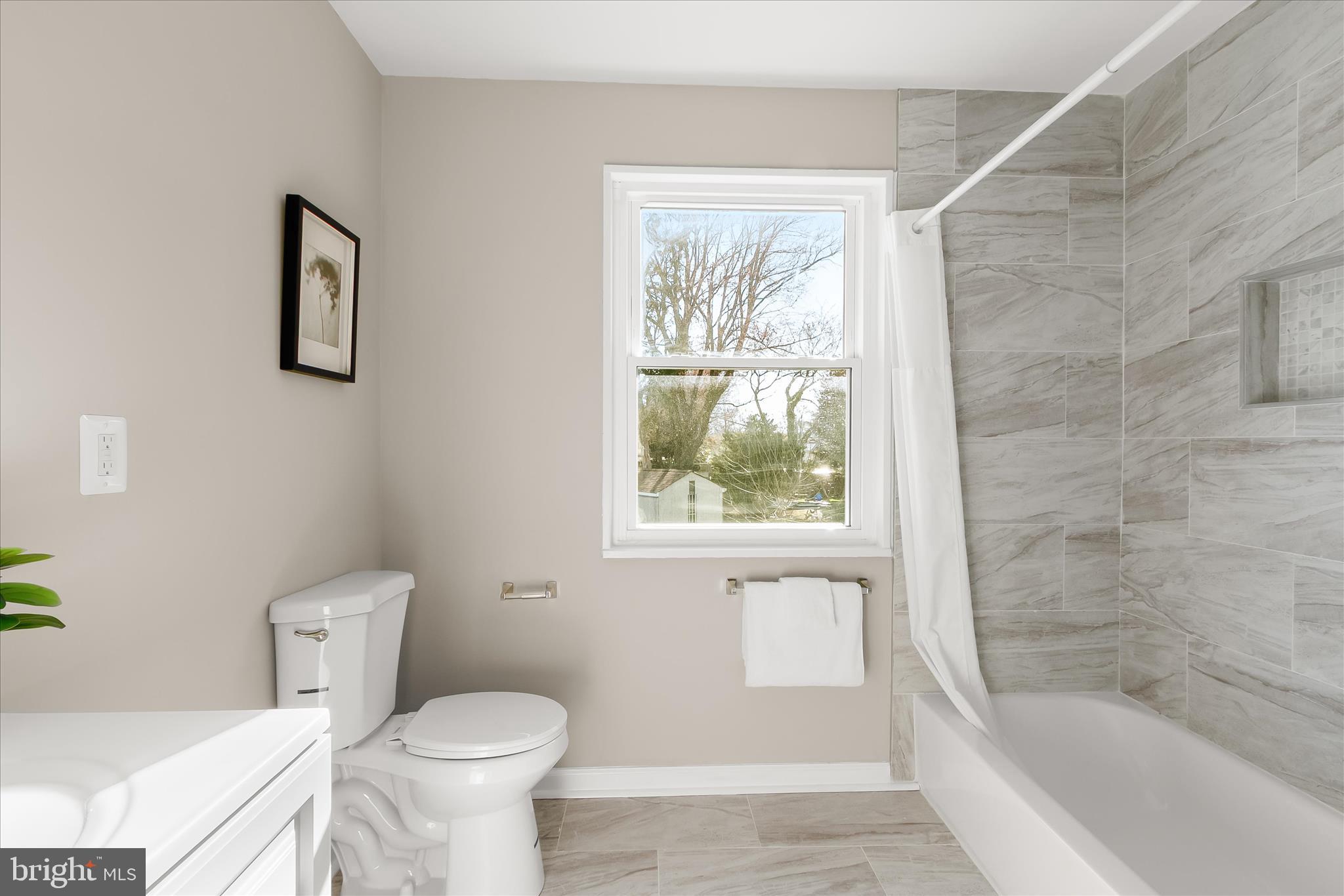 13218 Holdridge Road Silver Spring, MD 20906 - Photo 26 of 51 a bathroom with a toilet and a bathtub
