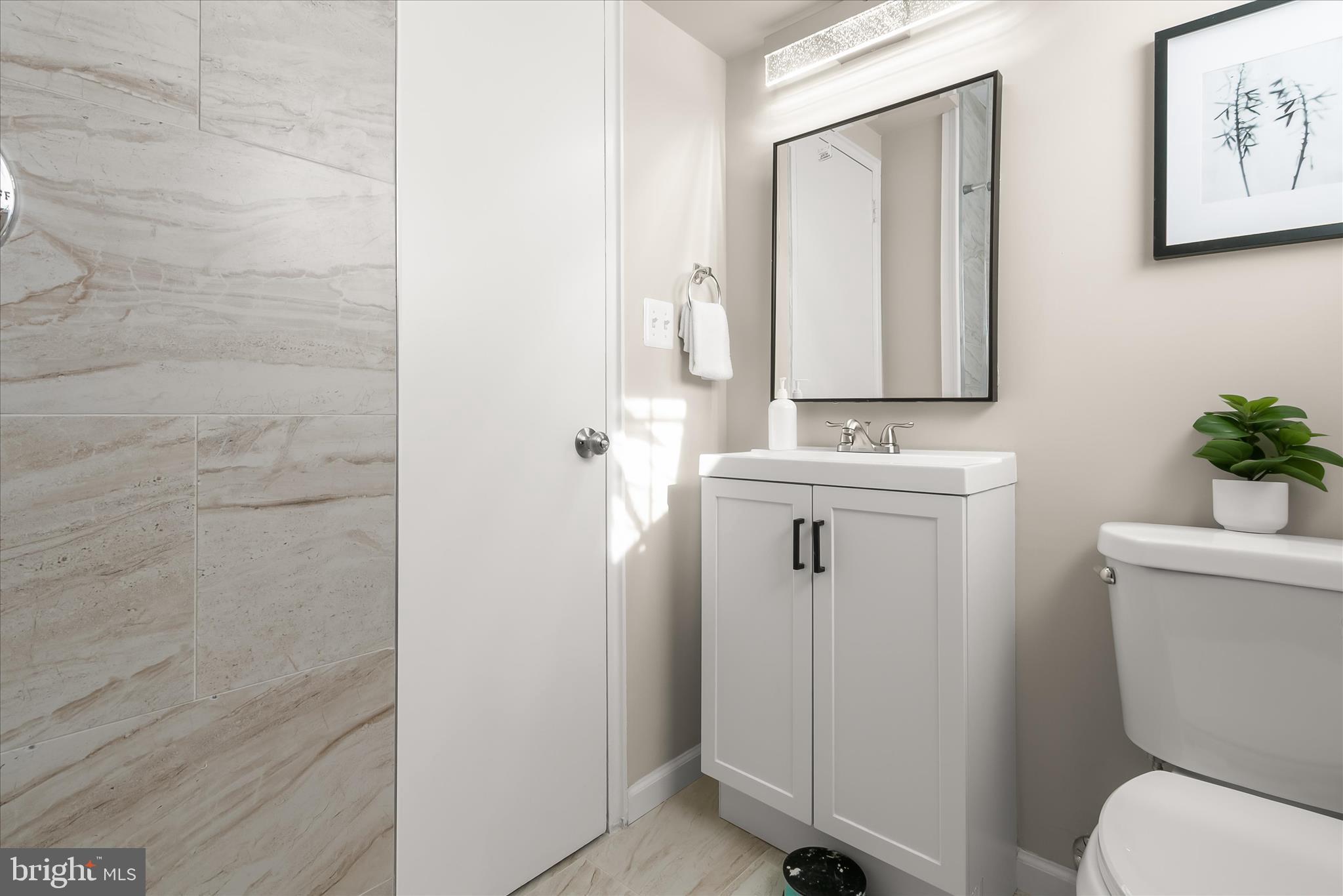 13218 Holdridge Road Silver Spring, MD 20906 - Photo 39 of 51 a bathroom with a toilet sink and mirror